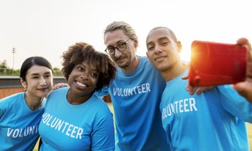 a-group-of-volunteers-taking-a-group-photograph-with-mobile-phone.SkL8KoWv0.jpg